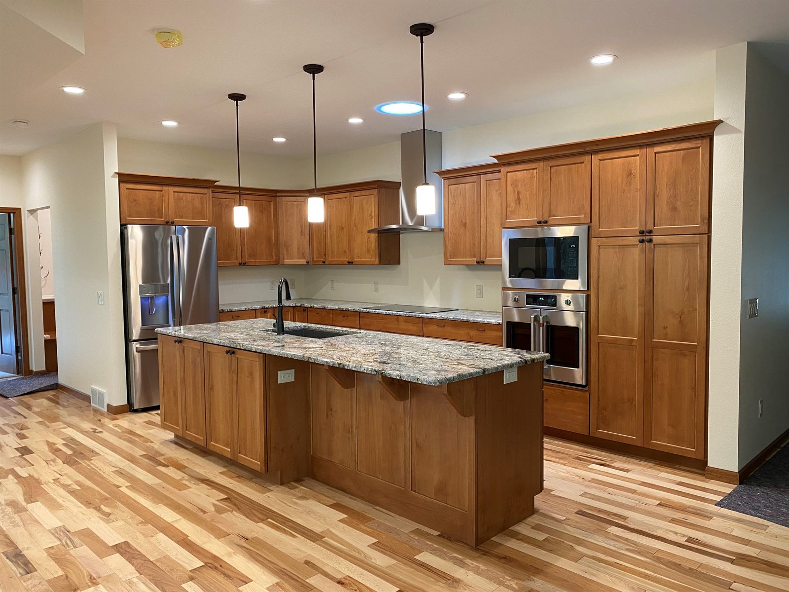Custom kitchen with cherry cabinetry and granite island