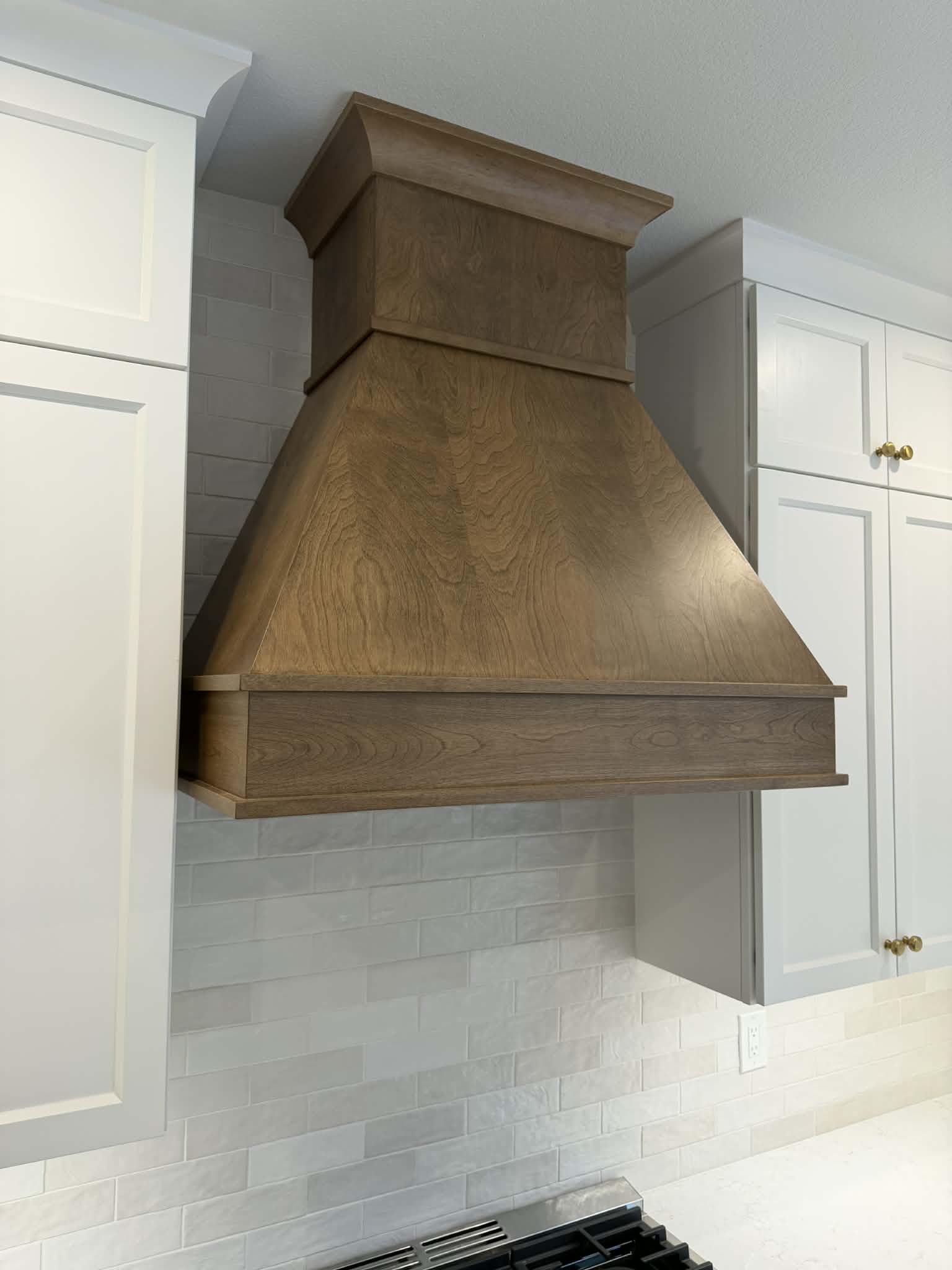 Custom wood range hood with stained finish