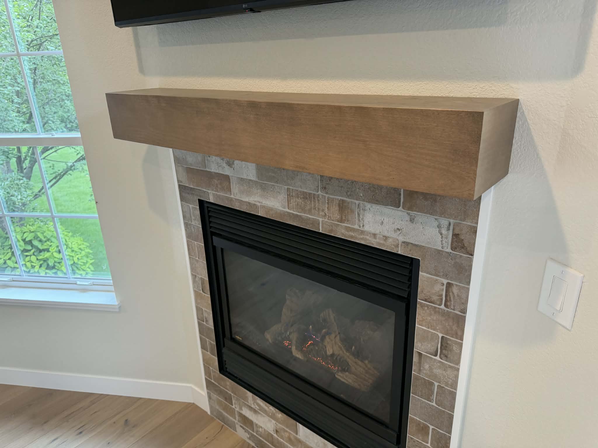 Custom wood fireplace mantel with stained finish